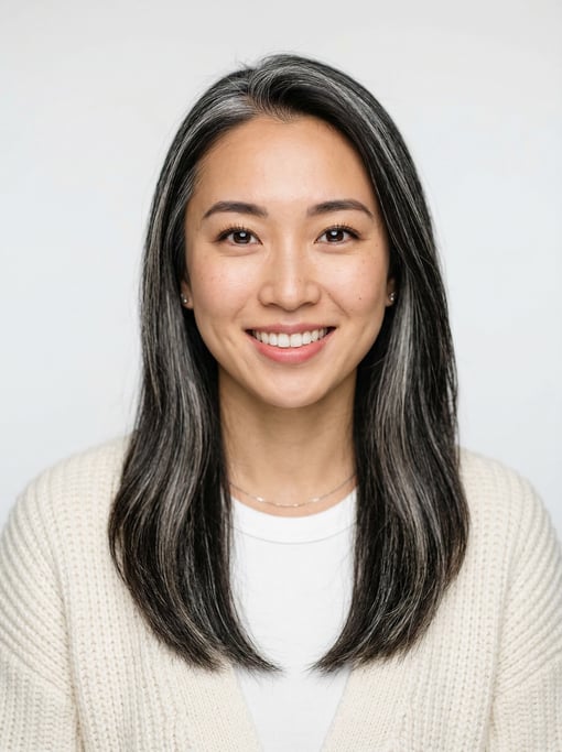 Professional studio headshot of a 25-year-old Japanese woman with long straight silver-streaked dark