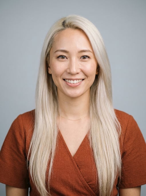Professional studio headshot of a 32-year-old Japanese woman with long straight platinum blonde hair