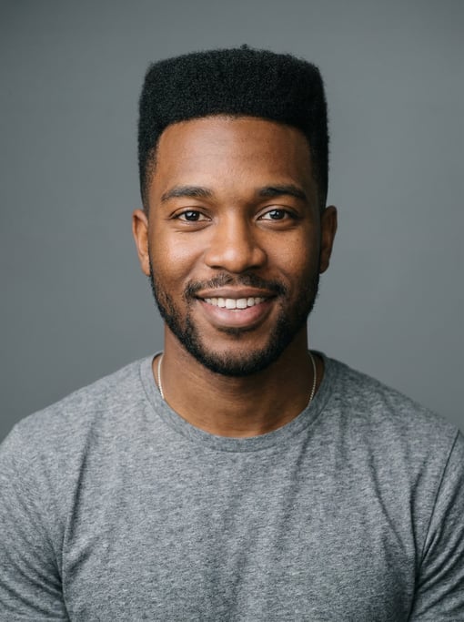 Professional studio headshot of a 25-year-old Black Caribbean man with a flat top in black