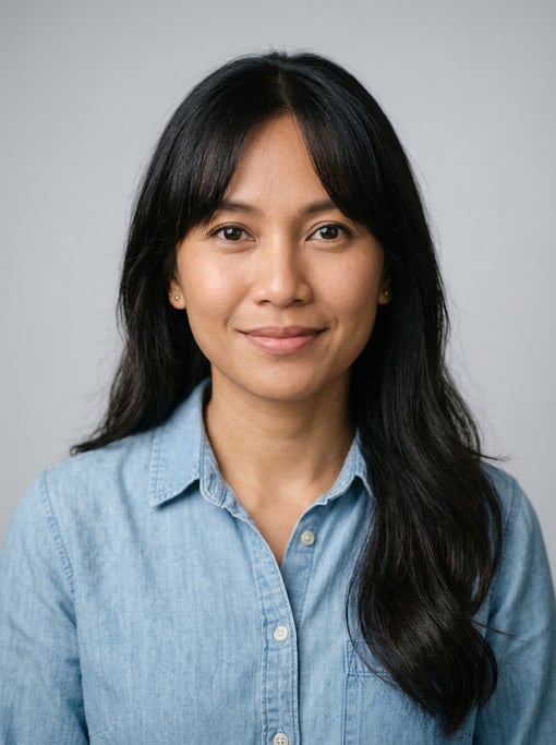 Professional studio headshot of a 36-year-old Indonesian woman with curtain bangs with long dark hai