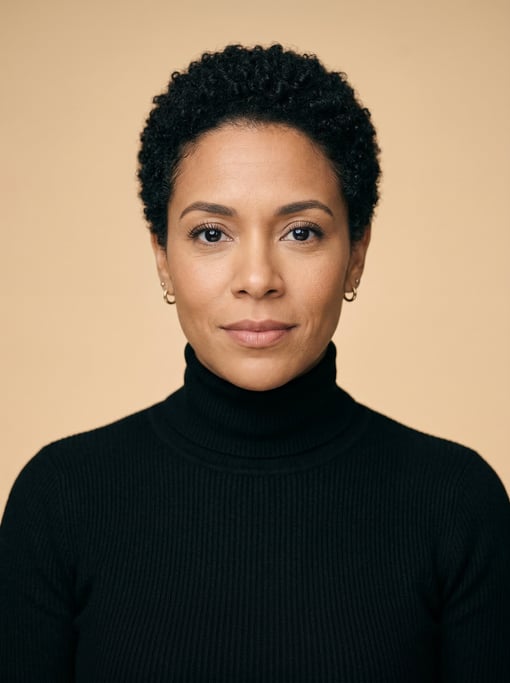 Professional studio headshot of a 37-year-old Latina woman with a short TWA hairstyle in black