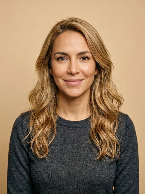 Professional studio headshot of a 37-year-old Colombian woman with long wavy honey blonde hair