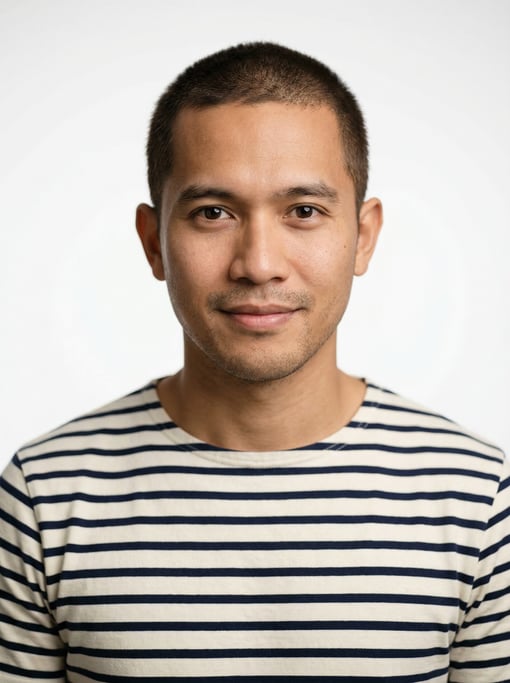 Professional studio headshot of a 29-year-old Indonesian man with short cropped dark brown hair