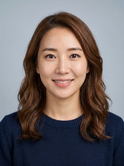 Professional studio headshot of a 29-year-old Korean woman with shoulder-length wavy chestnut hair