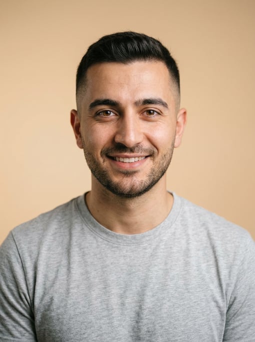 Professional studio headshot of a 25-year-old Turkish man with a short clean fade