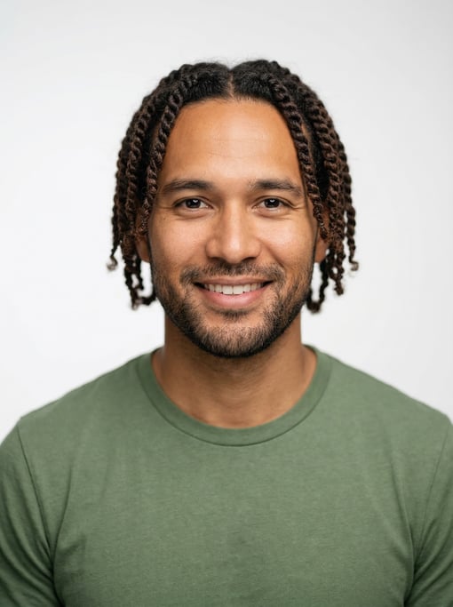 Professional studio headshot of a 32-year-old Hawaiian man with twists in dark brown