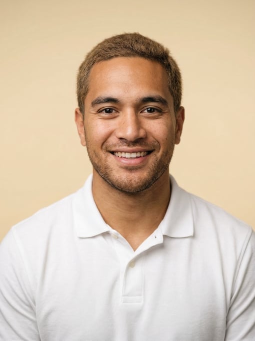 Professional studio headshot of a 27-year-old Polynesian man with short cropped sandy brown hair