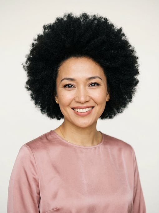 Professional studio headshot of a 36-year-old Central Asian woman with a full voluminous natural afr