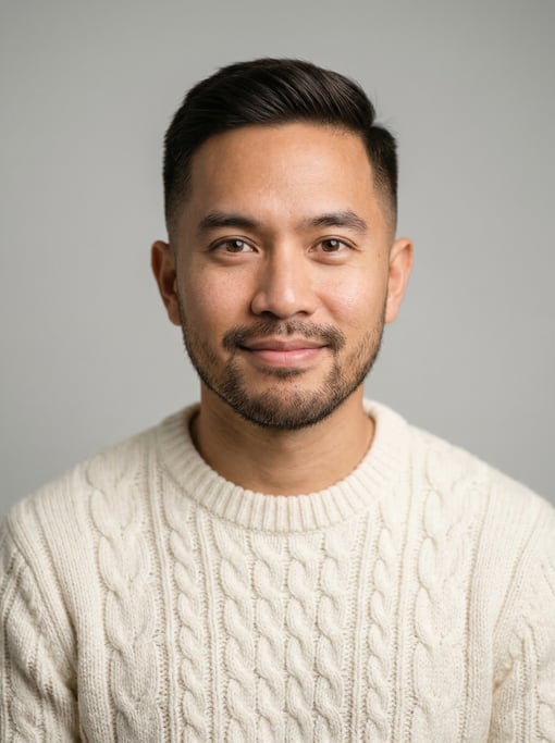 Professional studio headshot of a 33-year-old Thai man with a taper fade in dark brown
