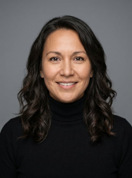 Professional studio headshot of a 39-year-old Native American woman with shoulder-length wavy dark h