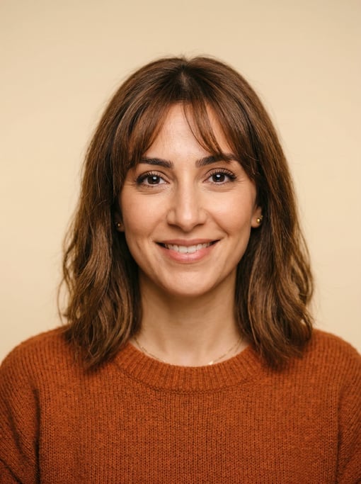 Professional studio headshot of a 32-year-old Middle Eastern woman with wispy bangs with a long bob
