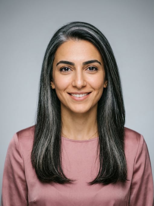Professional studio headshot of a 27-year-old Lebanese woman with long straight silver-streaked dark