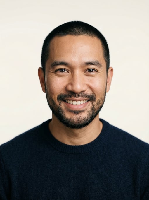 Professional studio headshot of a 37-year-old Thai man with a buzz cut in black