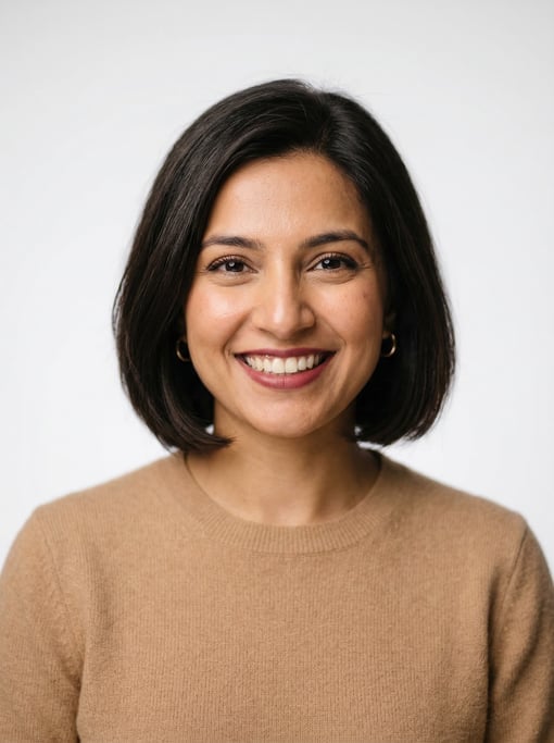 Professional studio headshot of a 31-year-old Pakistani woman with a chin-length bob in dark brown
