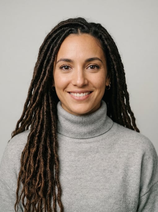 Professional studio headshot of a 28-year-old Argentinian woman with long goddess locs in dark brown