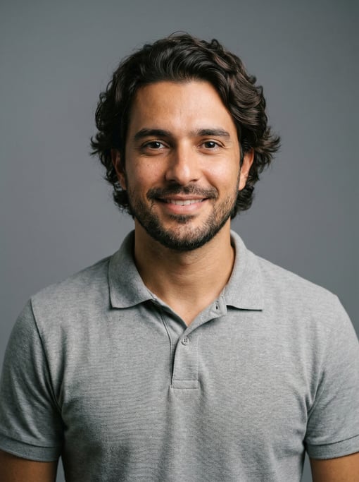Professional studio headshot of a 31-year-old Brazilian man with medium-length wavy dark brown hair