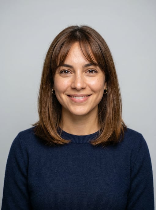 Professional studio headshot of a 24-year-old Cuban woman with wispy bangs with a long bob in warm b