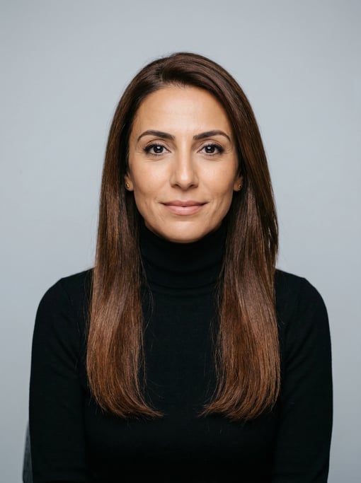 Professional studio headshot of a 40-year-old Middle Eastern woman with long straight chestnut hair