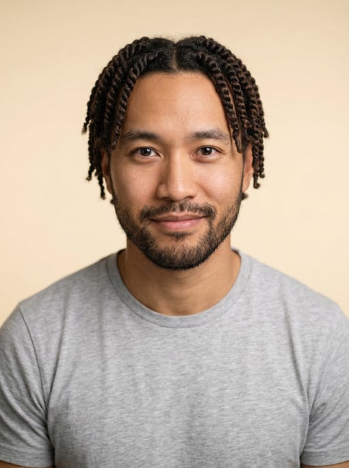 Professional studio headshot of a 35-year-old Chinese man with twists in dark brown