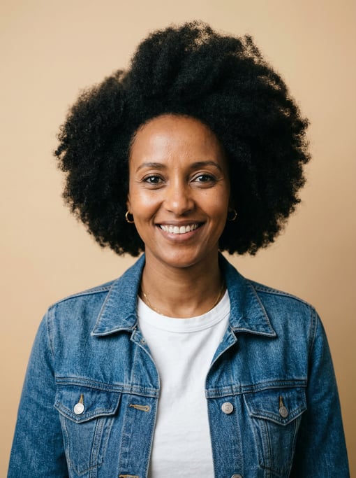 Professional studio headshot of a 40-year-old Ethiopian woman with a full voluminous natural afro in