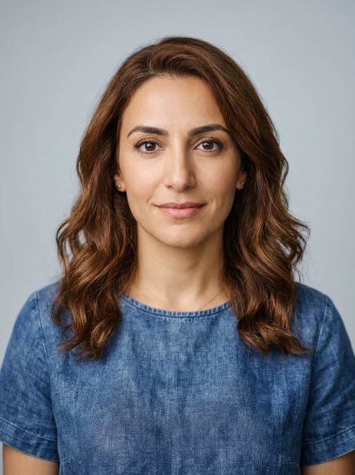 Professional studio headshot of a 35-year-old Middle Eastern woman with shoulder-length wavy chestnu