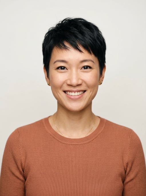 Professional studio headshot of a 35-year-old East Asian woman with a short pixie cut in black