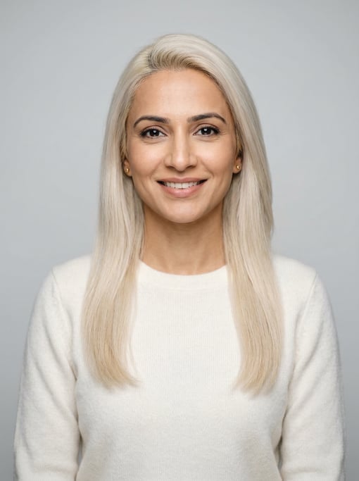 Professional studio headshot of a 39-year-old Pakistani woman with long straight platinum blonde hai