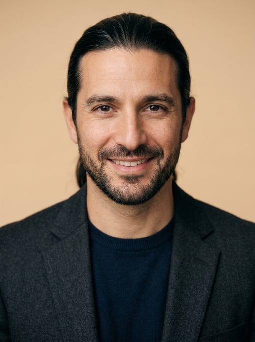 Professional studio headshot of a 40-year-old White Mediterranean man with long straight black hair