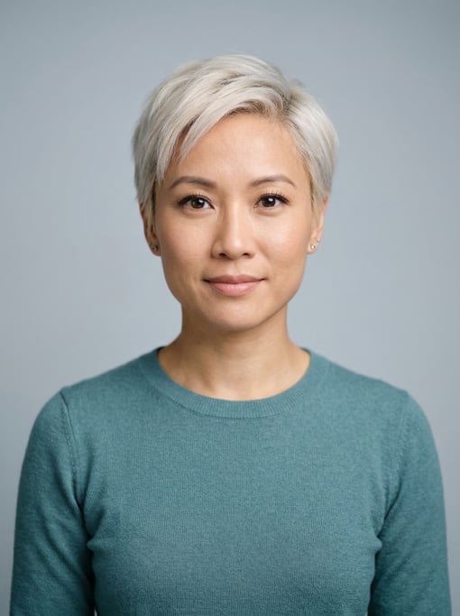Professional studio headshot of a 34-year-old Vietnamese woman with a short pixie cut in platinum bl