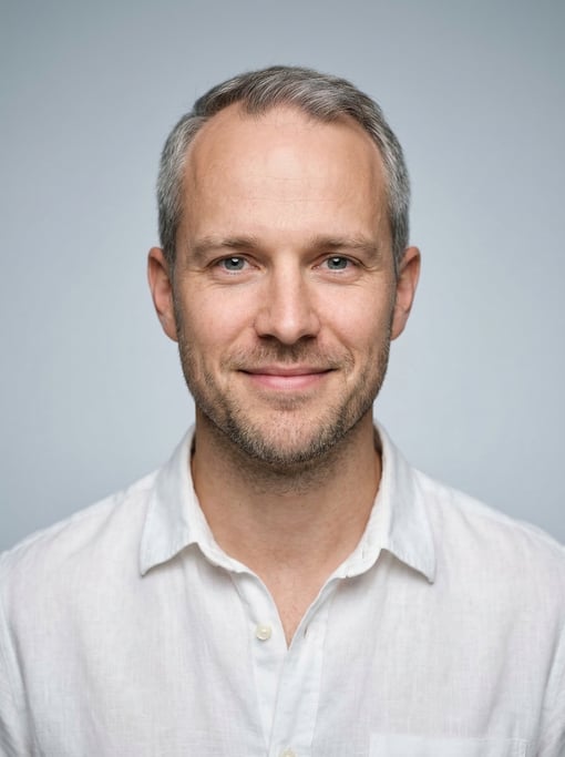 Professional studio headshot of a 31-year-old White Nordic man with receding hairline with short gre