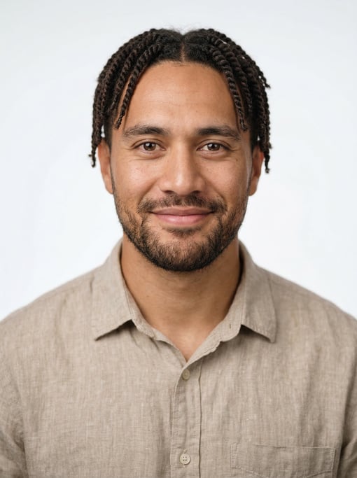 Professional studio headshot of a 29-year-old Maori man with twists in dark brown