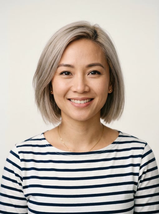 Professional studio headshot of a 32-year-old Vietnamese woman with a chin-length bob in ash blonde