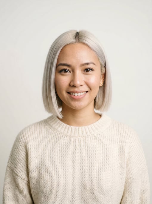 Professional studio headshot of a 26-year-old Southeast Asian woman with a blunt bob in platinum blo