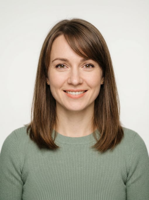 Professional studio headshot of a 30-year-old White Eastern European woman with shoulder-length stra