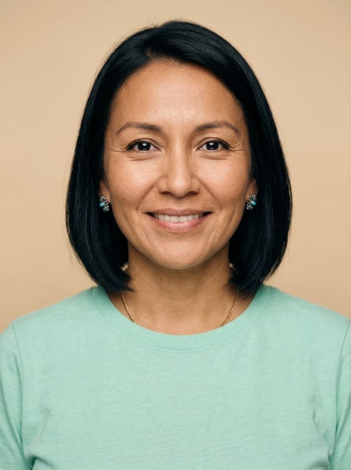 Professional studio headshot of a 37-year-old Native American woman with a chin-length bob in jet bl