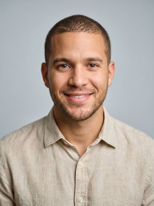 Professional studio headshot of a 27-year-old Dominican man with a buzz cut in brown