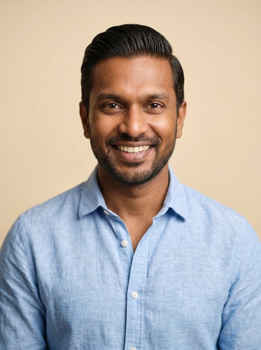 Professional studio headshot of a 39-year-old Sri Lankan man with a slicked-back style in dark brown