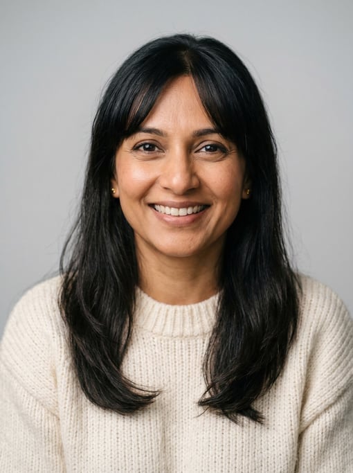 Professional studio headshot of a 40-year-old South Asian woman with curtain bangs with long dark ha