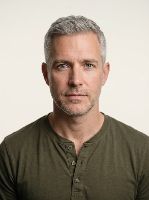 Professional studio headshot of a 38-year-old White European man with fully grey short cropped hair