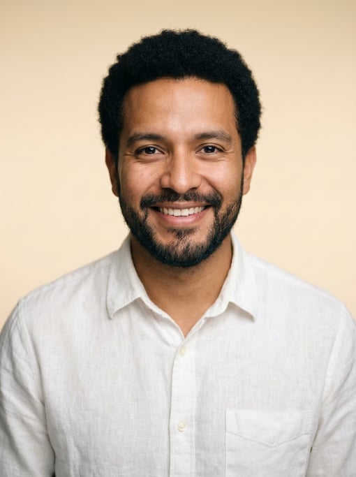 Professional studio headshot of a 33-year-old Mexican man with a short natural afro in black