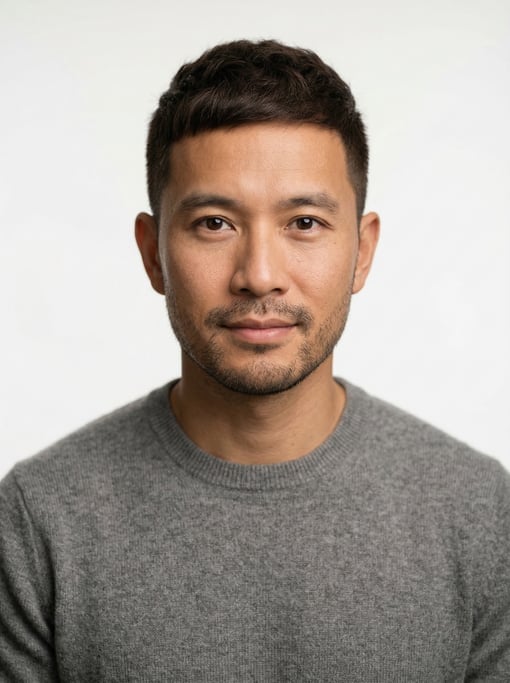 Professional studio headshot of a 35-year-old Vietnamese man with a dark brown textured crop