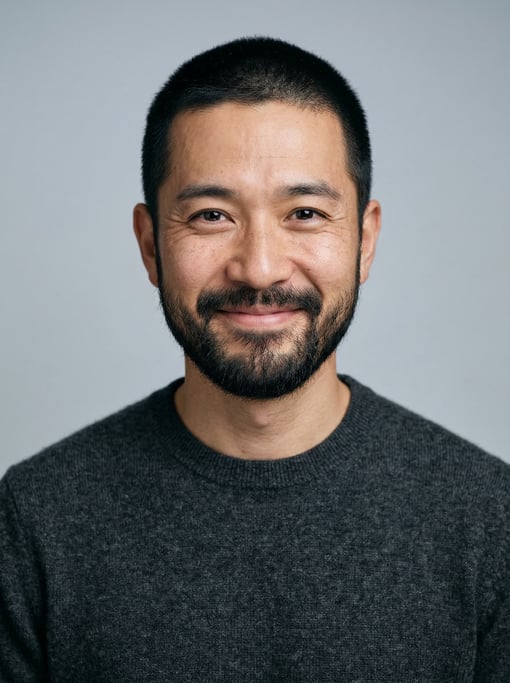 Professional studio headshot of a 37-year-old Japanese man with short cropped black hair