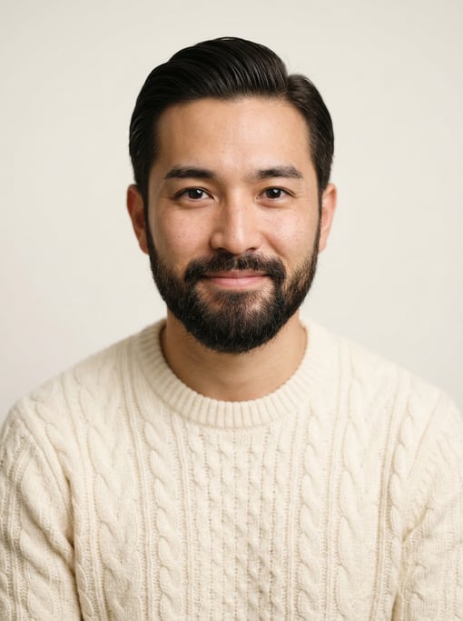 Professional studio headshot of a 29-year-old Japanese man with a slicked-back style in dark brown