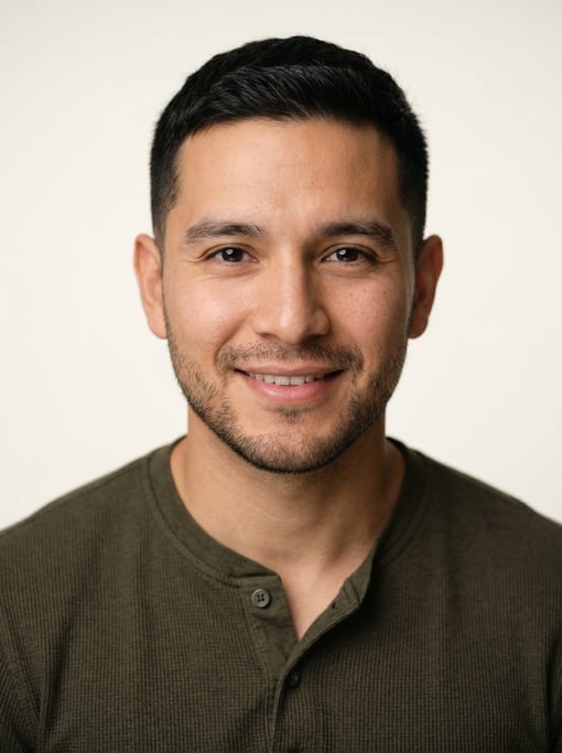 Professional studio headshot of a 27-year-old Latino man with a Caesar cut in black