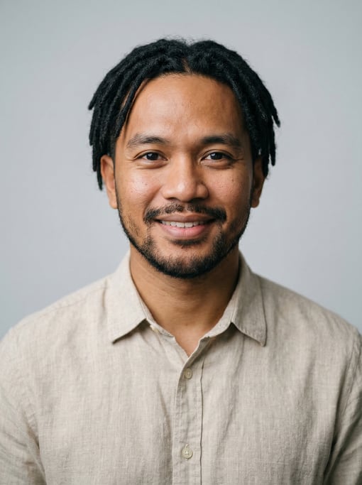 Professional studio headshot of a 30-year-old Filipino man with short locs in black