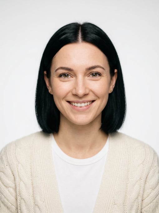 Professional studio headshot of a 25-year-old White European woman with a blunt bob in jet black wit