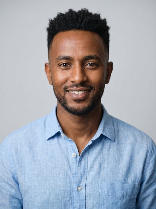Professional studio headshot of a 30-year-old Ethiopian man with a mid fade with textured top
