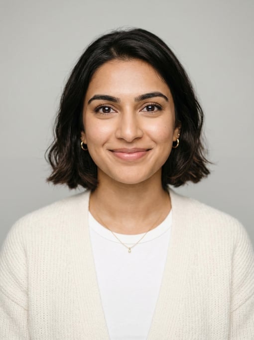 Professional studio headshot of a 24-year-old South Asian woman with a chin-length bob in dark brown