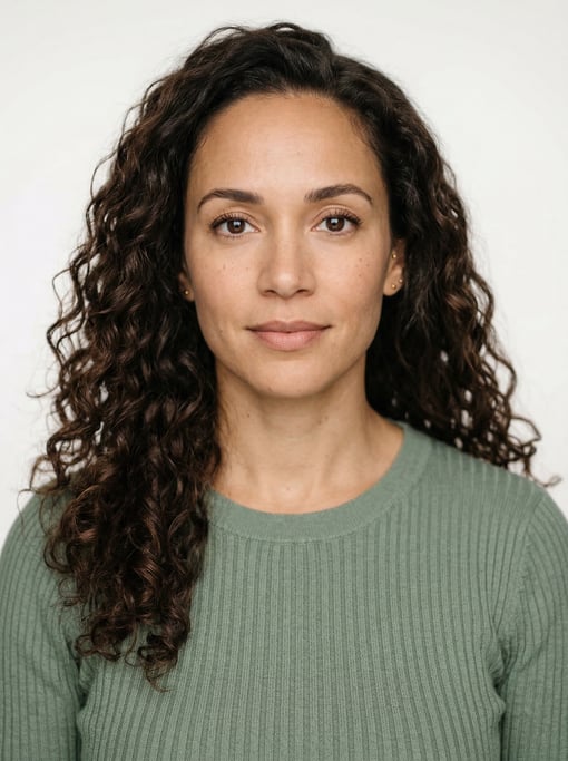 Professional studio headshot of a 37-year-old mixed-race woman with long loose curls in dark brown