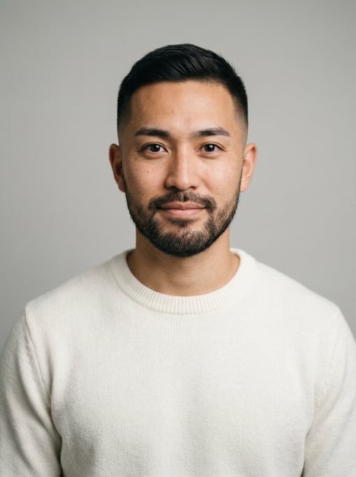 Professional studio headshot of a 29-year-old Japanese man with a short clean fade